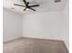 Spacious bedroom with carpet, a ceiling fan, and neutral decor at 3591 S Ranger Trl, Gilbert, AZ 85297