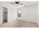 Bedroom with carpet, ceiling fan, and a door to the walk in closet at 3591 S Ranger Trl, Gilbert, AZ 85297