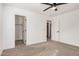 Bright bedroom with a ceiling fan, gray carpet, and white paint at 3591 S Ranger Trl, Gilbert, AZ 85297
