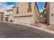 A three-car garage on a home exterior with a paver walkway and stone landscaping at 3591 S Ranger Trl, Gilbert, AZ 85297
