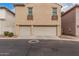 Two-car garage showcasing neutral doors and decorative balconies under second-story windows at 3591 S Ranger Trl, Gilbert, AZ 85297