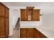 A kitchen with wood cabinets, stainless appliances, quartz counters, and a breakfast bar at 3591 S Ranger Trl, Gilbert, AZ 85297