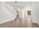 Open living space with tile flooring, white staircase, and an arched doorway leading to the kitchen at 3591 S Ranger Trl, Gilbert, AZ 85297