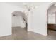 Spacious room featuring an open floor plan with modern lighting, tile flooring, and easy access to kitchen at 3591 S Ranger Trl, Gilbert, AZ 85297