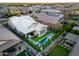 Beautiful aerial view showcases a home with a pool, putting green, and outdoor dining area at 3918 E Arabian Dr, Gilbert, AZ 85296