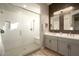 Elegant bathroom with a glass-enclosed shower, double vanity, and modern fixtures at 3918 E Arabian Dr, Gilbert, AZ 85296