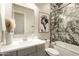 Stylish bathroom featuring marble wall accents, a sleek vanity, and elegant fixtures at 3918 E Arabian Dr, Gilbert, AZ 85296