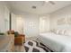 Cozy bedroom with a chair, a large window, and an attached bathroom at 3918 E Arabian Dr, Gilbert, AZ 85296