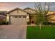 Charming home featuring a well-manicured lawn and a brick driveway leading to an attached two-car garage at 3918 E Arabian Dr, Gilbert, AZ 85296