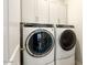 Well-equipped laundry room featuring modern washer and dryer units and ample white cabinetry at 3918 E Arabian Dr, Gilbert, AZ 85296