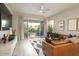 Bright living room with a leather sofa, modern decor, and sliding doors to a private patio at 3918 E Arabian Dr, Gilbert, AZ 85296