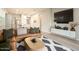 Open-concept living room with a leather sofa, modern rug, and a view of the kitchen at 3918 E Arabian Dr, Gilbert, AZ 85296