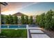 Sparkling pool with manicured landscaping, lounge chairs, and landscape lighting at 3918 E Arabian Dr, Gilbert, AZ 85296