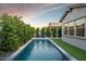 Sparkling pool with manicured landscaping, lounge chairs, and landscape lighting at 3918 E Arabian Dr, Gilbert, AZ 85296