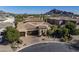 Stunning aerial view of the home showcasing its tile roof, lush landscaping and mountain views at 3980 E Sierra Vista Dr, Paradise Valley, AZ 85253