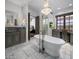 Elegant bathroom with a soaking tub, marble floors, and a vanity area at 3980 E Sierra Vista Dr, Paradise Valley, AZ 85253