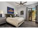 Comfortable bedroom features a door to the courtyard, modern fan, and stylish decor accents at 3980 E Sierra Vista Dr, Paradise Valley, AZ 85253