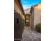 Inviting gated entryway with stone pathway leading to a grand chandelier-lit living space at 3980 E Sierra Vista Dr, Paradise Valley, AZ 85253