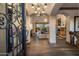 Grand foyer featuring custom iron door, elegant lighting, and wood flooring leading to an open living space at 3980 E Sierra Vista Dr, Paradise Valley, AZ 85253
