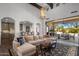 Open living room boasts vaulted ceilings, exposed beams, and a seamless transition to outdoor dining at 3980 E Sierra Vista Dr, Paradise Valley, AZ 85253
