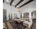Bright living room with beamed ceilings and large windows leads to the kitchen and outdoor areas at 3980 E Sierra Vista Dr, Paradise Valley, AZ 85253