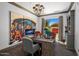 Bright home office featuring a large desk, stylish decor, and a view of the outdoors at 3980 E Sierra Vista Dr, Paradise Valley, AZ 85253