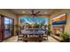 Comfortable outdoor dining area with a fireplace, and access to the pool and lounge chairs at 3980 E Sierra Vista Dr, Paradise Valley, AZ 85253