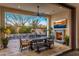 Beautiful outdoor dining area with a fireplace and views of the pool and desert landscape at 3980 E Sierra Vista Dr, Paradise Valley, AZ 85253