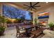 Elegant outdoor dining area featuring a stone fireplace, television, and a view of the pool at 3980 E Sierra Vista Dr, Paradise Valley, AZ 85253