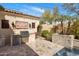 Covered outdoor kitchen featuring a built-in grill, stainless steel appliances, and desert landscaping at 3980 E Sierra Vista Dr, Paradise Valley, AZ 85253