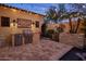 Outdoor kitchen and dining area with a built-in grill and string lights at 3980 E Sierra Vista Dr, Paradise Valley, AZ 85253