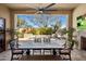 Covered patio with dining table and seating overlooking a sparkling pool with mature trees at 3980 E Sierra Vista Dr, Paradise Valley, AZ 85253