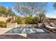 Sparkling pool with water feature and lounge chairs surrounded by mature desert landscaping at 3980 E Sierra Vista Dr, Paradise Valley, AZ 85253