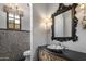 Stylish powder room with decorative walls, ornate mirror and custom vanity at 3980 E Sierra Vista Dr, Paradise Valley, AZ 85253