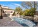 Sparkling swimming pool with cascading water features and an outdoor kitchen at 3980 E Sierra Vista Dr, Paradise Valley, AZ 85253