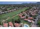 Expansive aerial view capturing the red-tiled community homes nestled alongside a scenic golf course and green landscaping at 4020 E Laurel Ln, Phoenix, AZ 85028