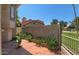 Private backyard oasis with patio, lush plants, and a view of the community pool at 4020 E Laurel Ln, Phoenix, AZ 85028