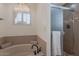 Soaking tub and tiled shower in a well-lit bathroom at 4020 E Laurel Ln, Phoenix, AZ 85028