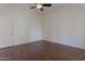 Neutral bedroom featuring hardwood floors, white door, and a ceiling fan at 4020 E Laurel Ln, Phoenix, AZ 85028