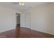 Neutral bedroom featuring hardwood floors, closet, ceiling fan, and white paint at 4020 E Laurel Ln, Phoenix, AZ 85028