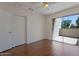 Bright bedroom featuring hardwood floors, a ceiling fan, closet, and access to an outdoor patio at 4020 E Laurel Ln, Phoenix, AZ 85028