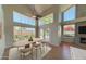 Sunlit dining area with large windows and an adjacent fireplace, perfect for entertaining at 4020 E Laurel Ln, Phoenix, AZ 85028