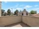 View from the outdoor balcony of neighborhood homes with brown roofs and lush green trees at 4020 E Laurel Ln, Phoenix, AZ 85028
