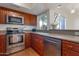 Updated kitchen with stainless steel appliances, granite countertops, and natural light at 4020 E Laurel Ln, Phoenix, AZ 85028