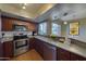 Stylish kitchen with stainless steel appliances and breakfast bar seating at 4020 E Laurel Ln, Phoenix, AZ 85028