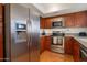 Modern kitchen with stainless steel appliances, sleek cabinets, and ample counter space at 4020 E Laurel Ln, Phoenix, AZ 85028