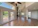 Bright and airy living room with hardwood floors, fireplace, high ceilings, and patio access at 4020 E Laurel Ln, Phoenix, AZ 85028
