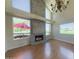 Bright living room with a cozy fireplace, hardwood floors, and ample natural light at 4020 E Laurel Ln, Phoenix, AZ 85028