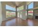 Sun-filled living room with hardwood floors, fireplace, high ceilings, and scenic views at 4020 E Laurel Ln, Phoenix, AZ 85028