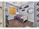 Cozy bedroom designed for a baseball lover, featuring hardwood floors and natural light at 41369 W Parkhill Dr, Maricopa, AZ 85138